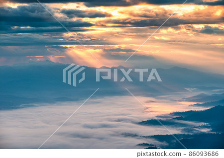 Sunbeam shining through cloudy over Doi Luang Chiang Dao mountain and foggy in the morning 86093686