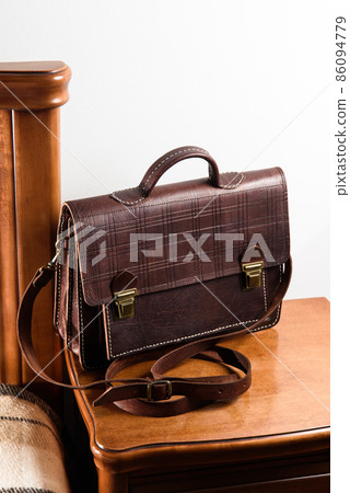 Brown leather briefcase with two locks. hotel room photo 86094779