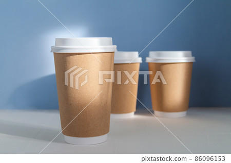 group of paper cups against blue background, greenwashing concept group of paper cups against blue background, greenwashing concept 86096153