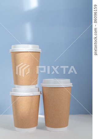 group of paper cups against blue background, greenwashing concept group of paper cups against blue background, greenwashing concept 86096159