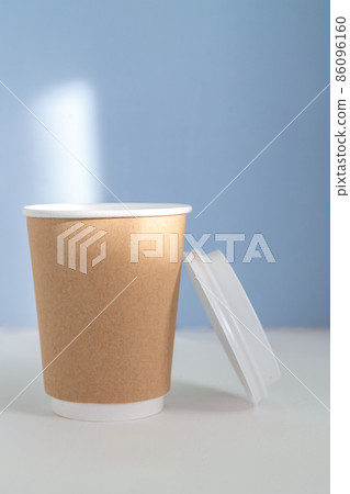group of paper cups against blue background, greenwashing concept 86096160