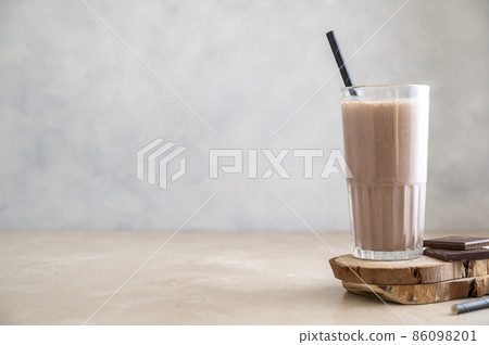 Chocolate protein drink in glass for nutrients and energy, fitness drink Chocolate protein drink in glass for nutrients and energy, fitness drink 86098201