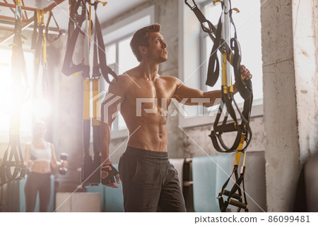 Athletic man getting ready for workout in the gym Athletic man getting ready for workout in the gym 86099481
