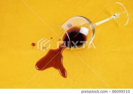 a spilled glass of wine on the tablecloth. Cleaning clothes and furniture from stains. 86099510