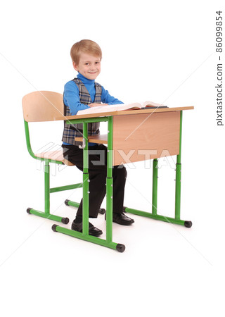 Boy sitting at a school desk 86099854