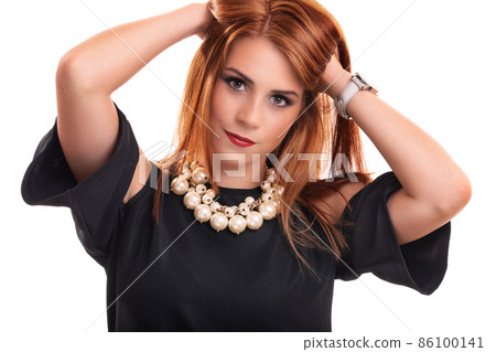 Young redhead woman with hands in her hair Young redhead woman with hands in her hair 86100141