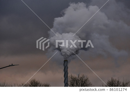 Air pollution, closeup of one big smoking pipe on the winter sky 86101274