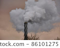 Air pollution, closeup of one smoking pipe during sunrise. 86101275