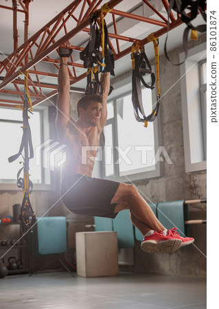 Young sporty man working out in the gym Young sporty man working out in the gym 86101874