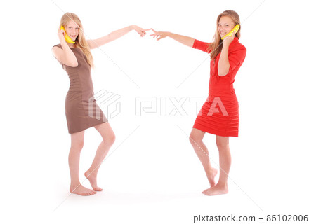 Two beautiful young caucasian girl with banana phone Two beautiful young caucasian girl with banana phone 86102006