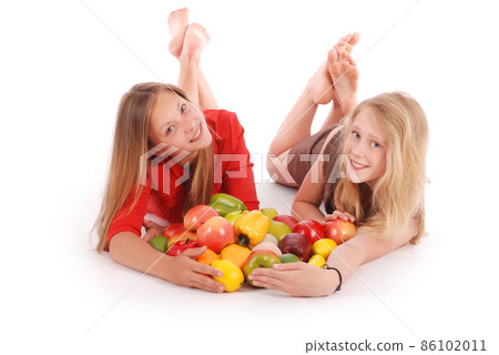 Two girls holding fresh fruits Two girls holding fresh fruits 86102011