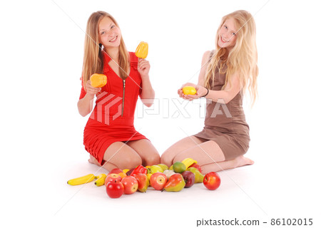 Two girls holding fresh fruits 86102015