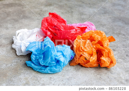 Colorful plastic bags on cement floor 86103228