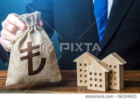 Turkish lira money bags and residential buildings figures. Investments in real estate and construction industry. Rental business. Sale of housing. Buy. Municipal budget. Bank offer of mortgage loan. 86104033