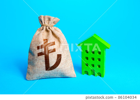 Turkish lira money bag and green building. Investment in green technologies. Reduced emissions and improved energy efficiency. Reducing impact on environment. Investments in sustainable housing. 86104034