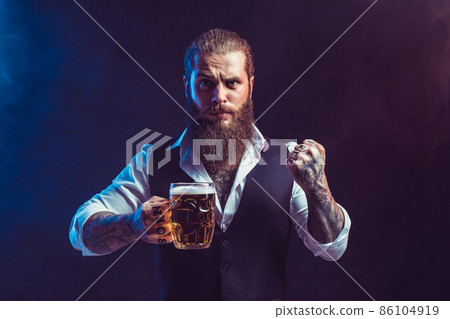 Emotional bearded man holds mug of tasty draft beer in hand while gesturing. October fest concept Emotional bearded man holds mug of tasty draft beer in hand while gesturing. October fest concept 86104919