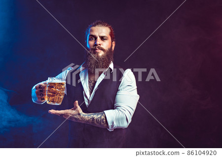 Hipster bearded man holds tasty draft beer in hand while gesturing. Drinking, October fest concept. Hipster bearded man holds tasty draft beer in hand while gesturing. Drinking, October fest concept. 86104920
