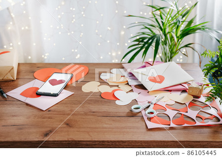 Desk with handmade Valentine greeting cards Desk with handmade Valentine greeting cards 86105445