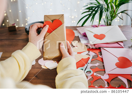 Woman holding a gift with Kimono-style wrap 86105447