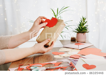 Woman holding a gift with Kimono-style wrap Woman holding a gift with Kimono-style wrap 86105448