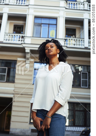 young pretty african girl posing cheerful on city background, lifestyle outdoor people concept young pretty african girl posing cheerful on city background, lifestyle outdoor people concept 86105888