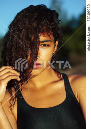 young pretty african curly girl on sunset on beach sexy looking, lifestyle people concept 86106020