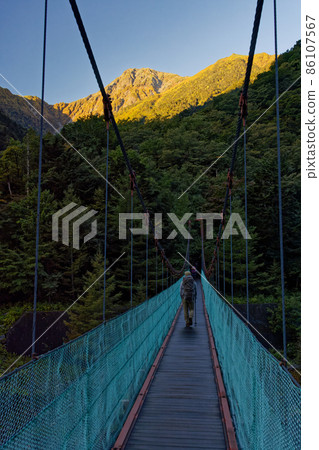 The summit of Mt. Kitadake in the Southern Alps seen from the suspension bridge in Hirokawara The summit of Mt. Kitadake in the Southern Alps seen from the suspension bridge in Hirokawara 86107567
