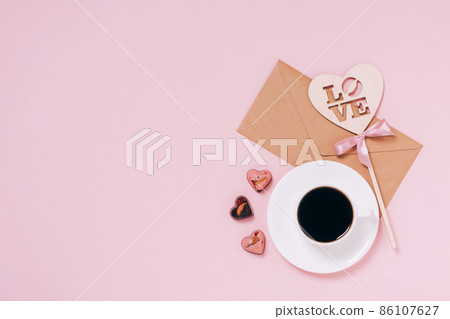 Chocolates festive box cup of coffee, hearts, an envelope pink background. Festive composition for Valentine's Day 86107627