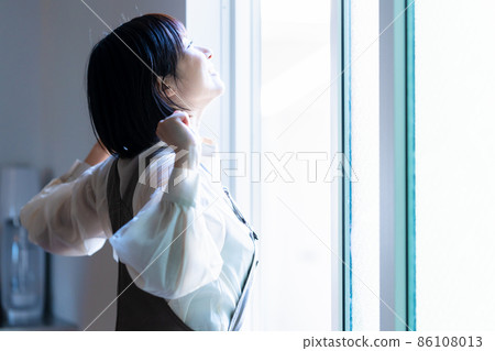 A woman basking in the morning sun 86108013