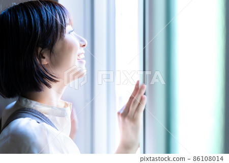 A woman basking in the morning sun A woman basking in the morning sun 86108014