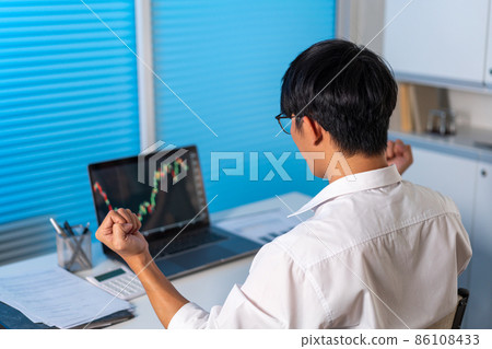 Overwork Concept The man sitting at the desk in the office raising his hand with happy emotion Overwork Concept The man sitting at the desk in the office raising his hand with happy emotion 86108433