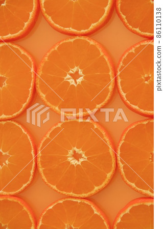 Close to the vertical composition of slices of oranges lined up closely Close to the vertical composition of slices of oranges lined up closely 86110138