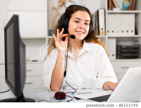 Young positive woman customer support phone operator 86111739