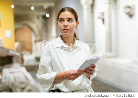 Woman visiting sculpture hall in historical museum Woman visiting sculpture hall in historical museum 86112628
