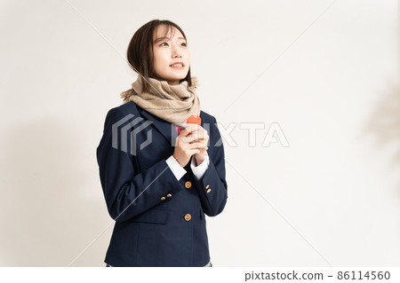 A high school girl praying for success with a talisman A high school girl praying for success with a talisman 86114560