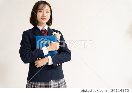 High school girl standing with a diploma High school girl standing with a diploma 86114570