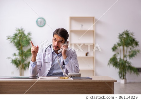 Young male doctor in telemedicine concept 86114829