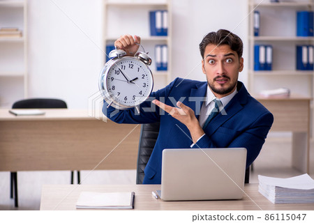 Young male employee in time management concept 86115047
