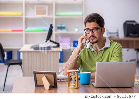Young male designer working in the office Young male designer working in the office 86115677