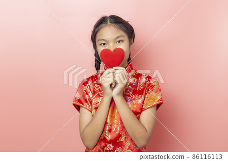 Portrait of Asian girl wearing a red dress Chinese, Chinese New Year Concept,Girl holding red heart shape 86116113