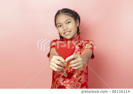 Portrait of Asian girl wearing a red dress Chinese, Chinese New Year Concept,Girl holding red heart shape 86116114
