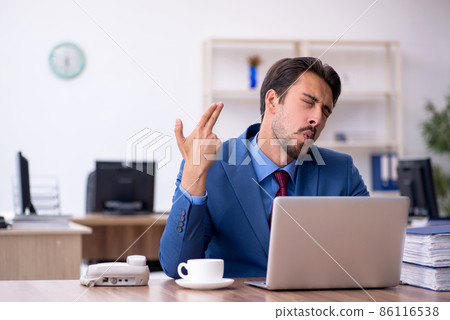 Young male employee working in the office Young male employee working in the office 86116538