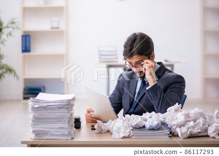 Young male employee in brainstorming concept 86117293