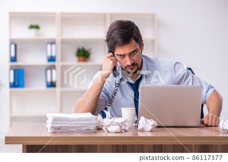 Young male employee rejecting new ideas in the office Young male employee rejecting new ideas in the office 86117377