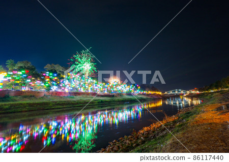 Fireworks at the waterfront with lights at Phitsanulok, Thailand. Fireworks at the waterfront with lights at Phitsanulok, Thailand. 86117440