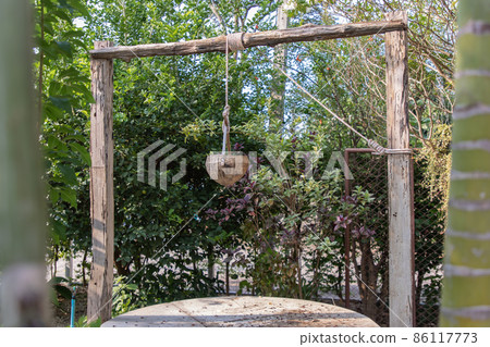 Old wooden well (water source) in traditional village folk style. Old wooden well (water source) in traditional village folk style. 86117773