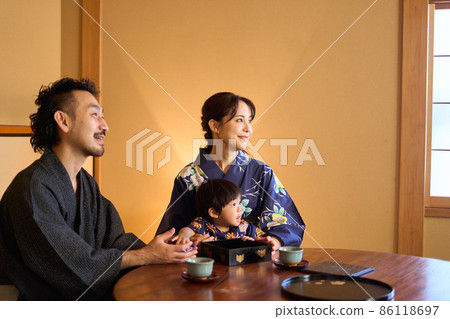 A family of three relaxing at the inn 86118697