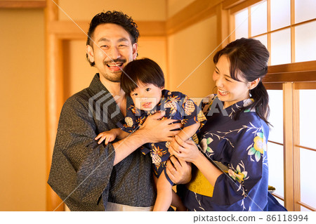 A family of three relaxing at the inn A family of three relaxing at the inn 86118994