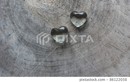 Two transparent hearts on rough surface of an old stump. Perfect Valentine's Day greeting card background. 86122038