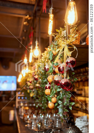Fir branch with balls and festive lights on the Christmas background. Fir branch with balls and festive lights on the Christmas background. 86122389